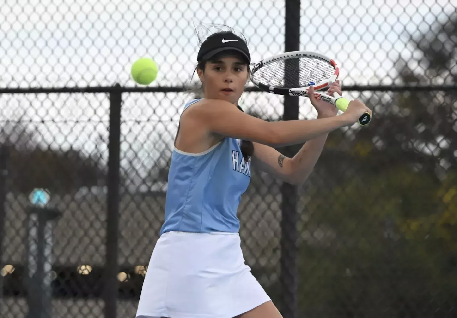 image of a girl playing tennis